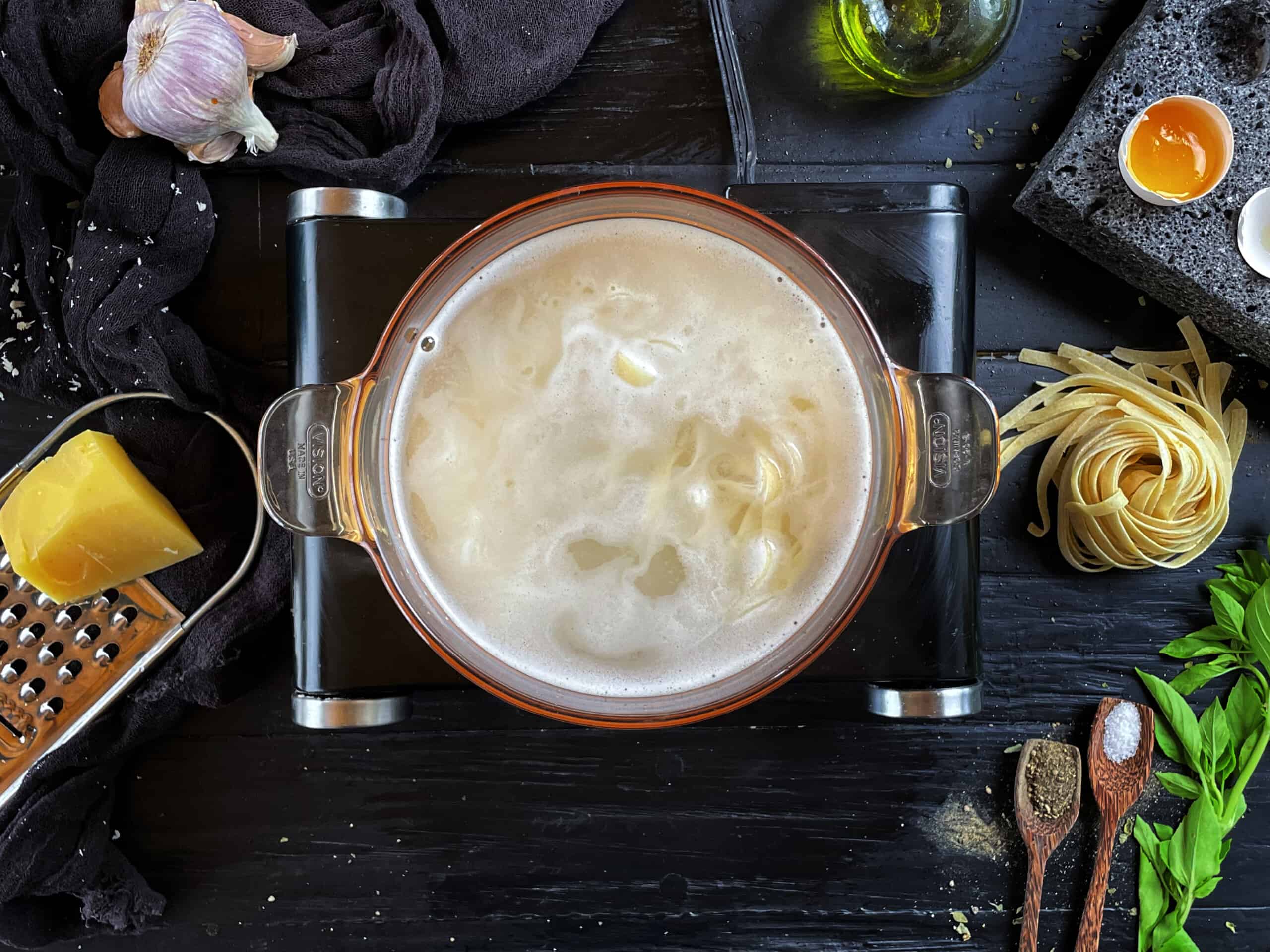 Cooking fettuccine on a big pot of water