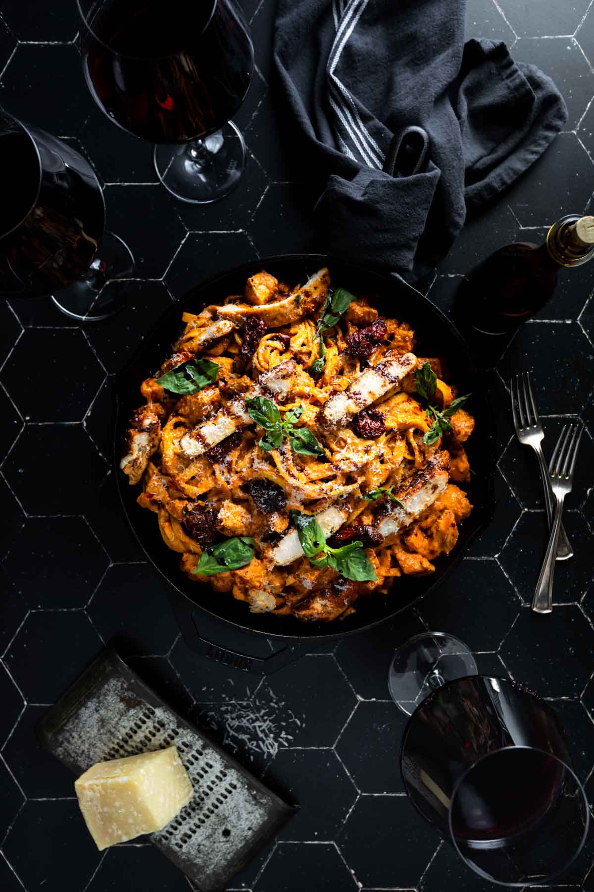 A big skillet of chicken fettuccine alfredo in a sun dried tomato cream sauce