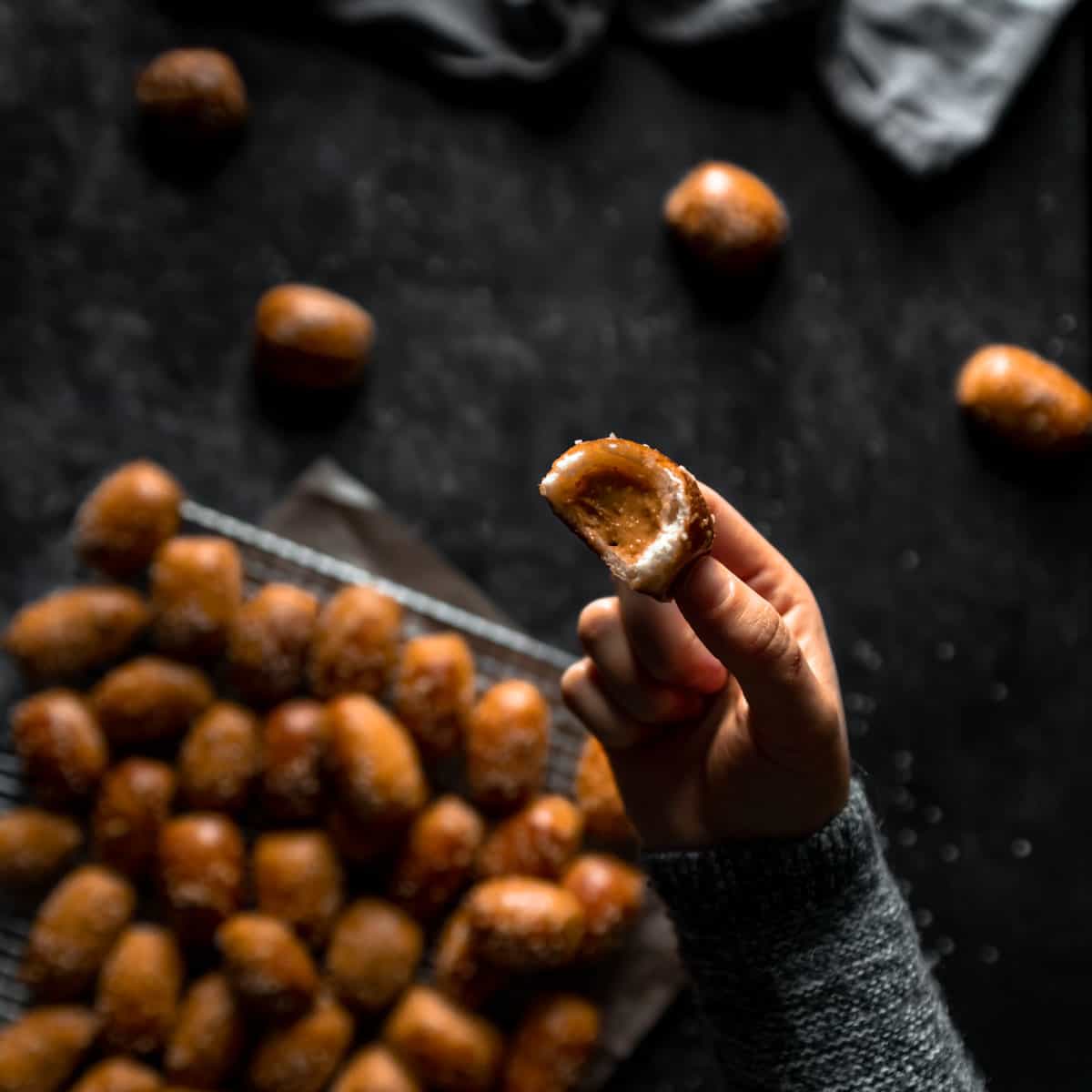 hand holding a peanut butter stuffed pretzel with a bite taken out