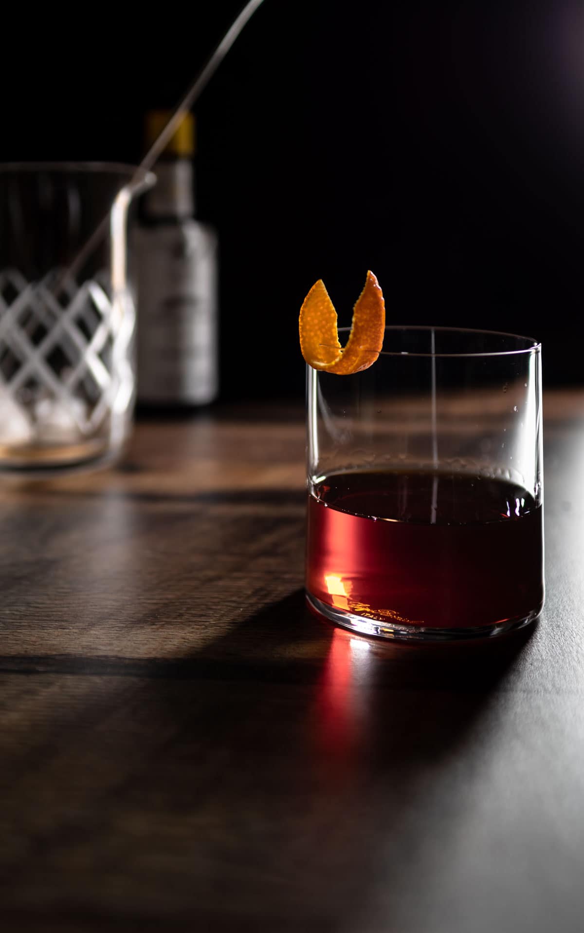 bitter old fashioned being served in a cocktail glass