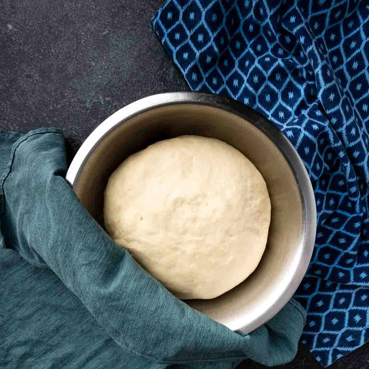 A big fluffy ball of pita dough after being proofed. 