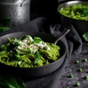 Bowl of Green Pea Pasta topped with burrata cheese