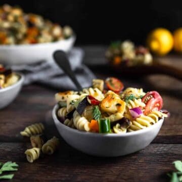 a bowl full of Halloumi Pasta Salad with a fork sticking out