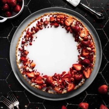 overhead shot of a Coconut Tart with a crescent design of Strawberries