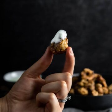 holding a fried morel mushroom that was dipped in a lemon Crema