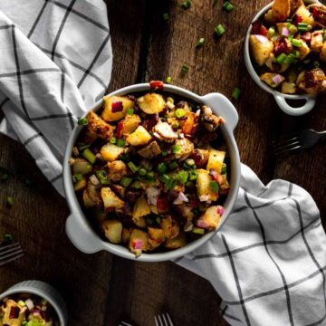 an overhead view of a bowl full of fried potato salad