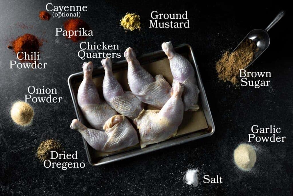 a picture of all the ingredients needed to make smoked chicken quarters : chicken legs, chili powder, onion powder, dried oregano, ground mustard, garlic powder, brown sugar, paprika, salt and optional cayenne