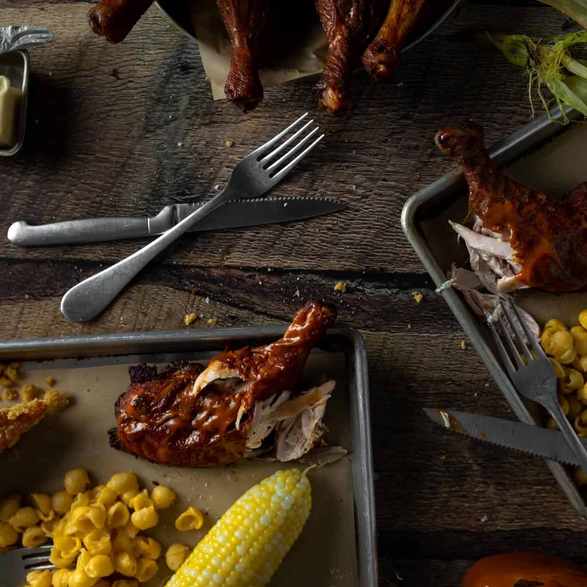 Trays of smoked chicken quarters with Mac and cheese, cornbread and corn on the cob