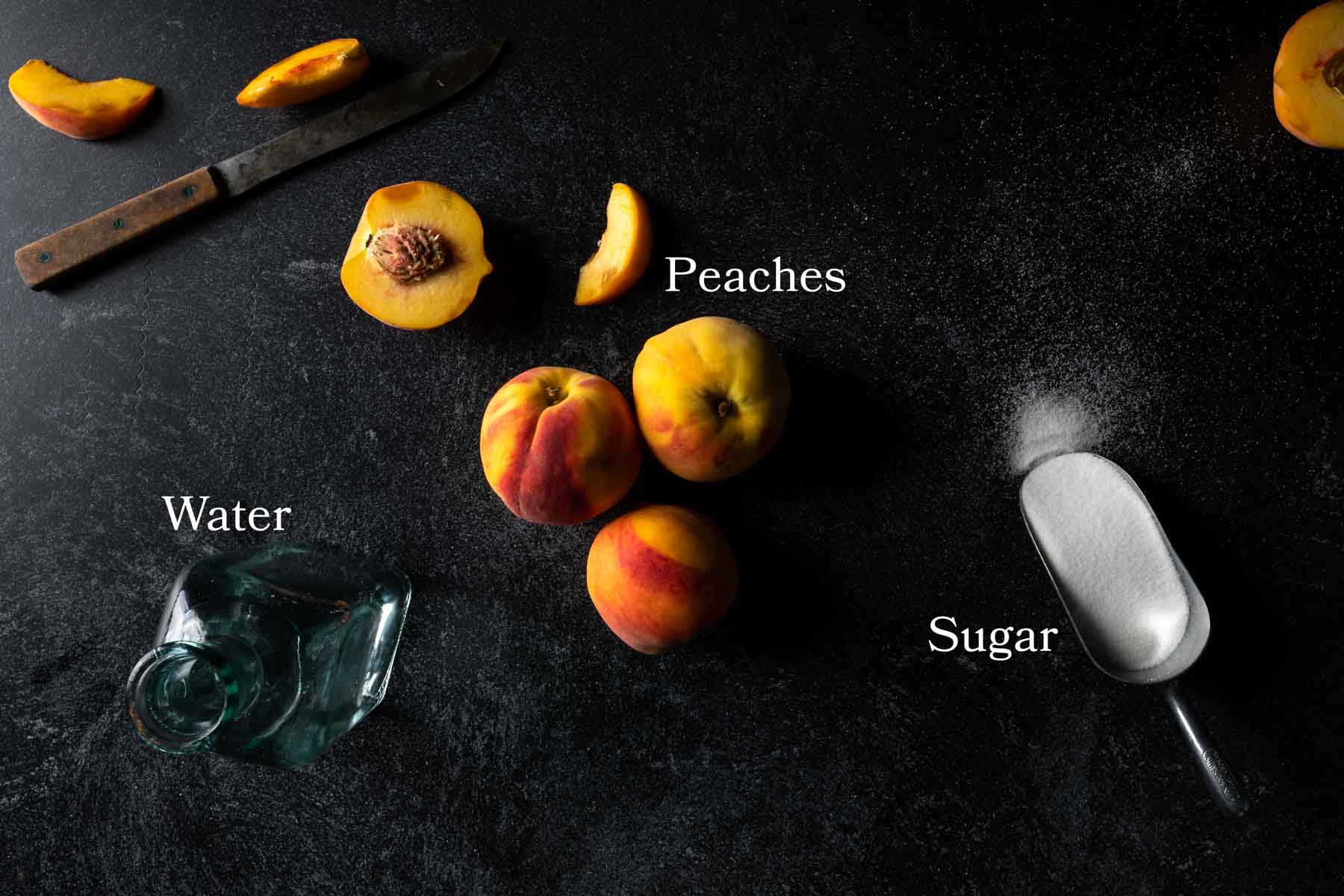 Ingredients needed for peach syrup including fresh peaches, water, and granulated sugar