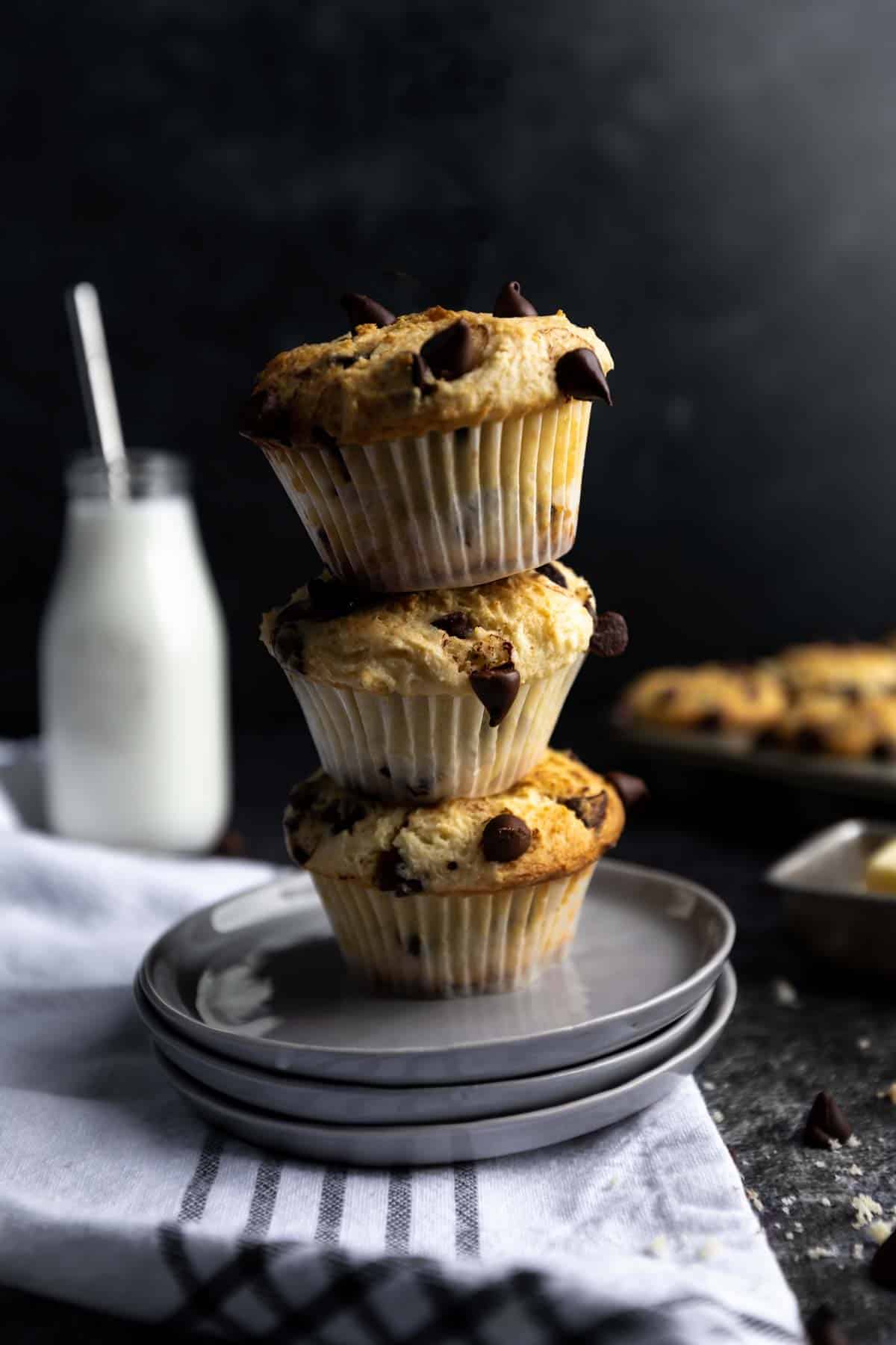 three chocolate chip muffins stacked on top of each other.