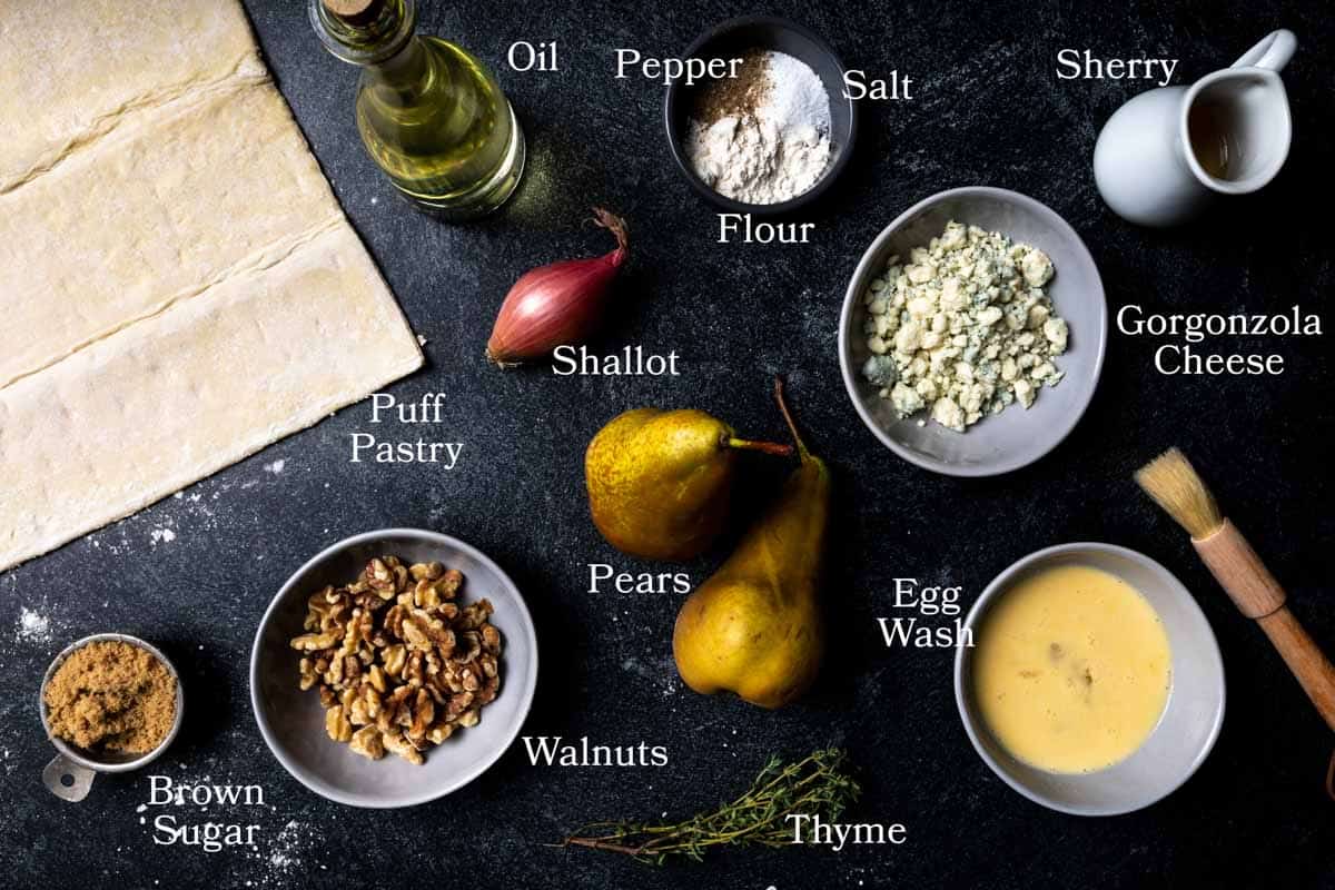 A picture of ingredients for this recipe: puff pastry, pears, shallot, walnuts, thyme, gorgonzola cheese, brown sugar, oil, sherry cooking wine, flour, salt, pepper and egg wash