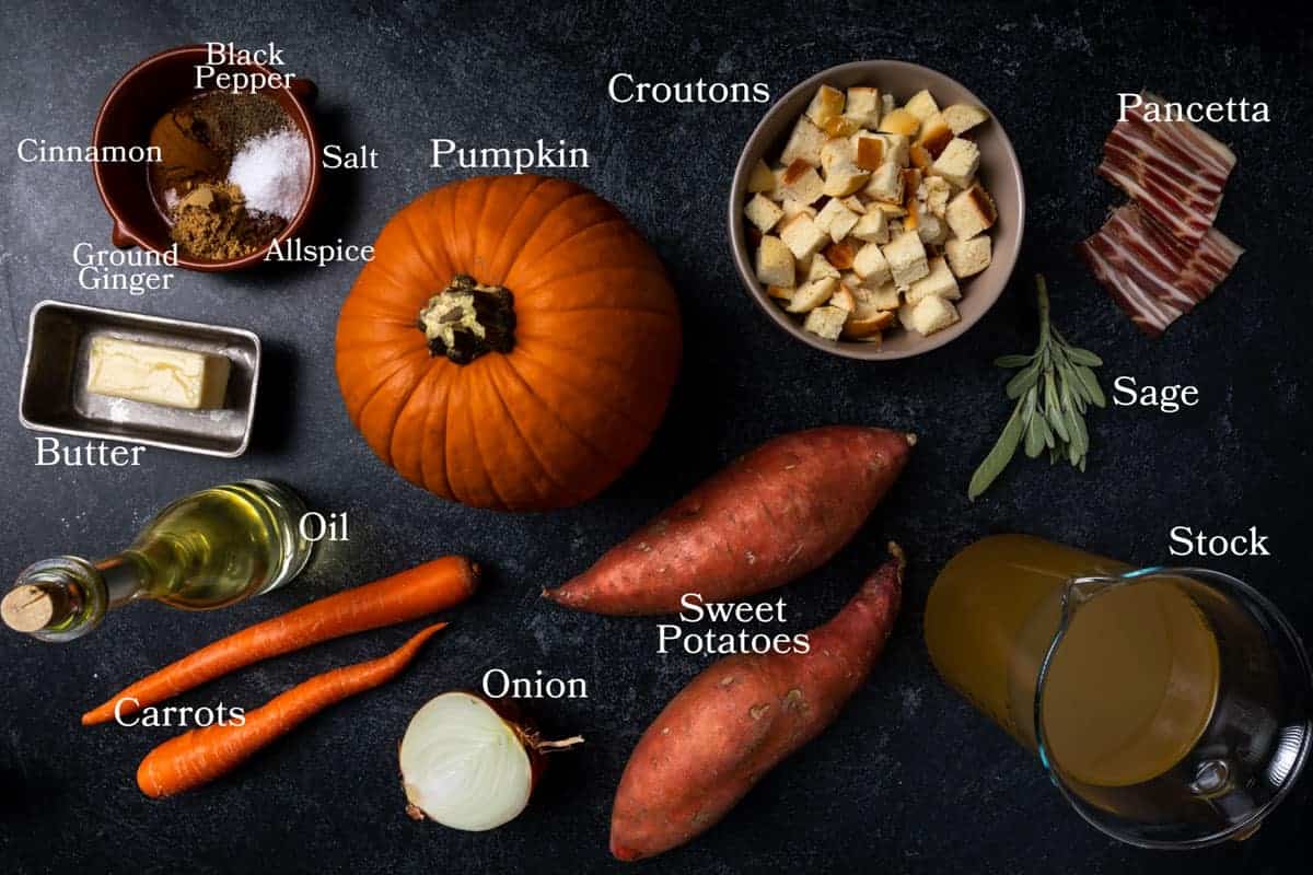 A photo of ingredients for this soup including pumpkin, sweet potato, carrots, yellow onion, stock, cinnamon, ginger, allspice, salt, pepper, oil, butter, croutons, pancetta and sage