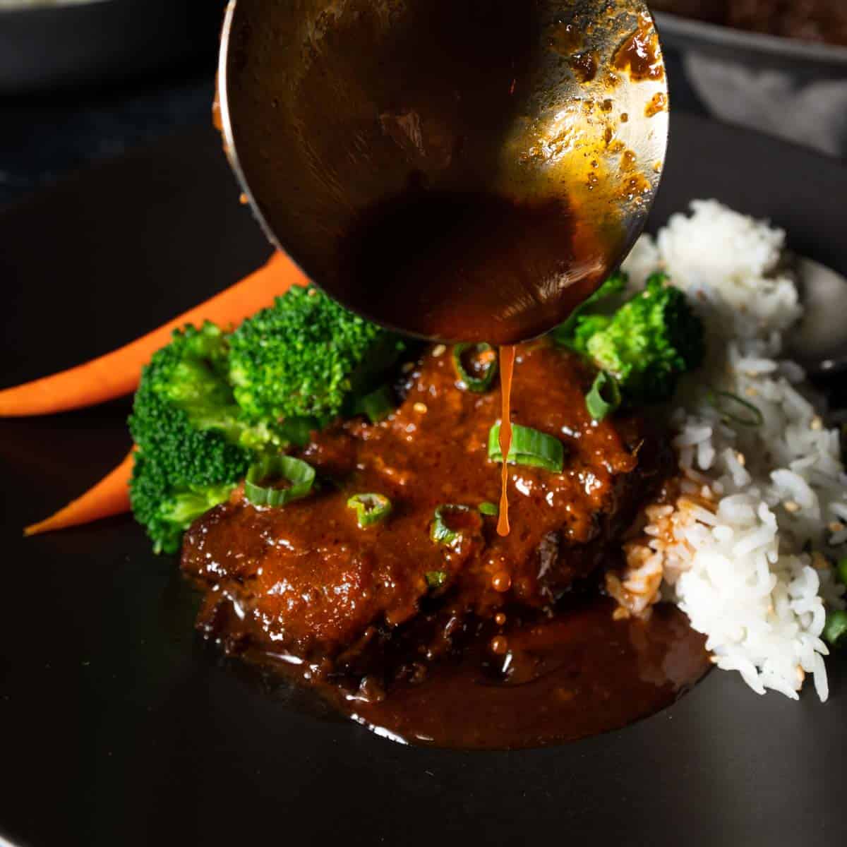 A ladle pouring Korean marinade over a tender braised beef short rib