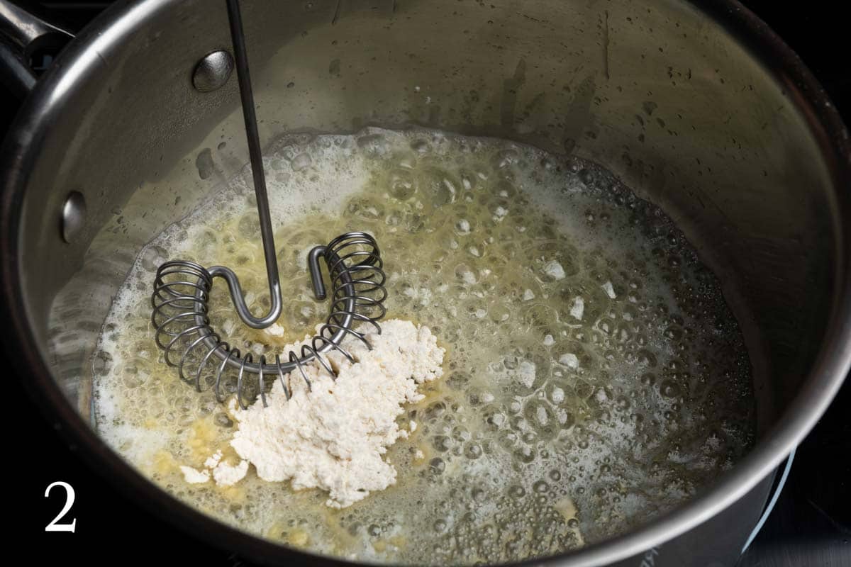 Whisking flour into melted butter to make a roux