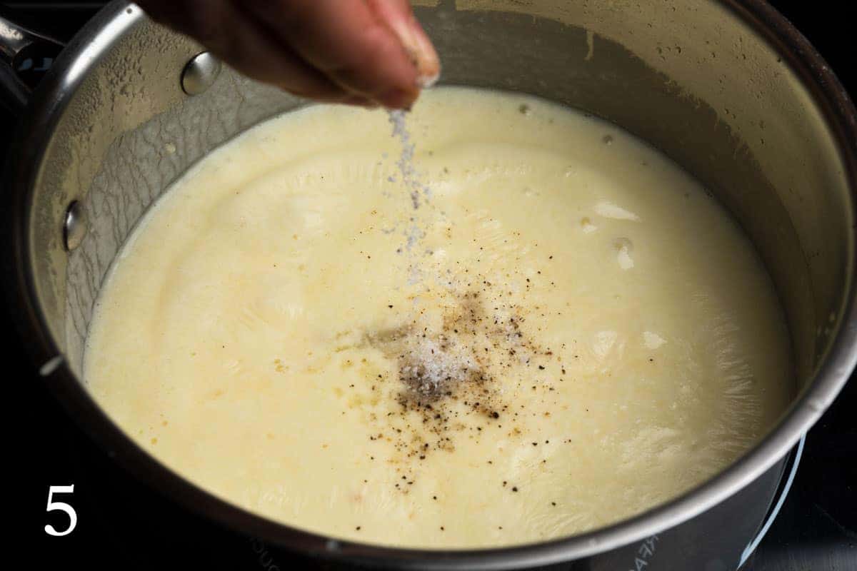 Seasoning the fondue sauce with salt and pepper
