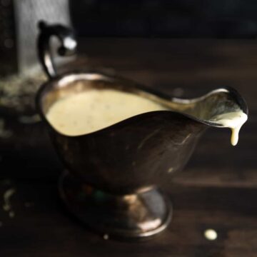 Sauce mornay cheese fondue sauce dripping from a gravy boat