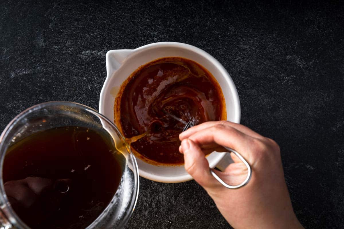 whisking beef stock into Korean marinade