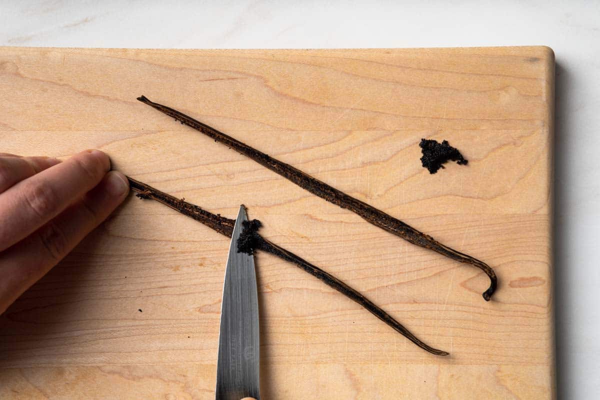 Scraping the seeds from a vanilla bean with a pairing knife