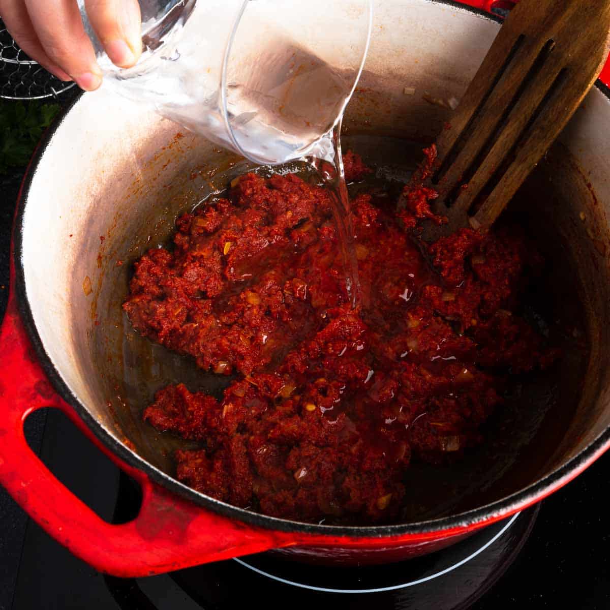 Adding vodka to the 'Nduja sauce