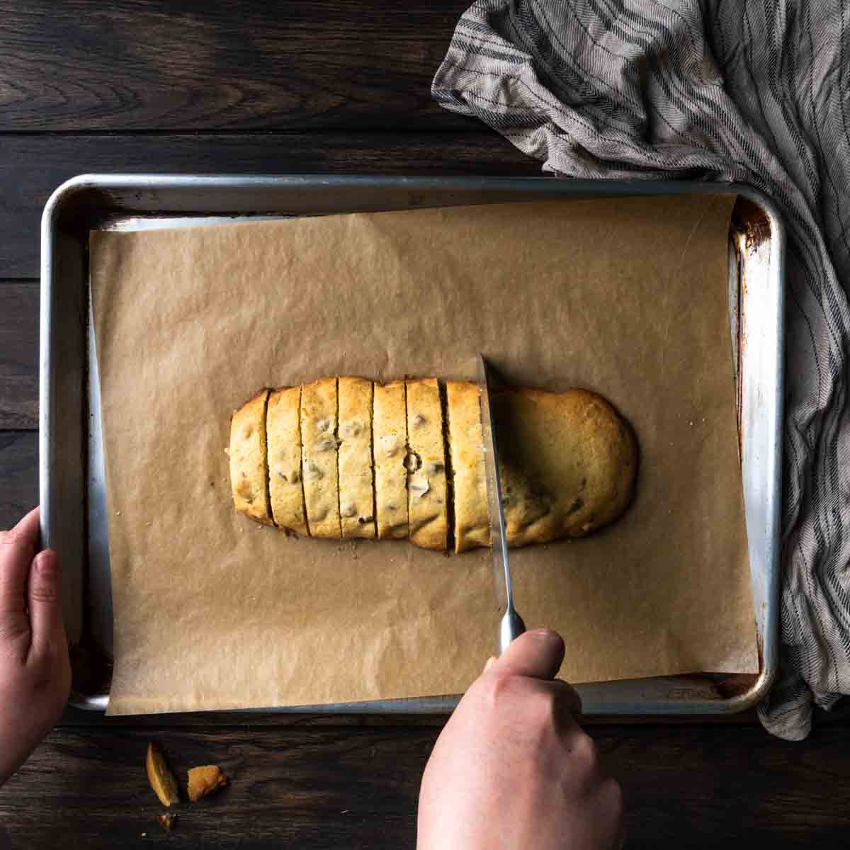 Slicing the biscotti log into cookies with a sharp knife