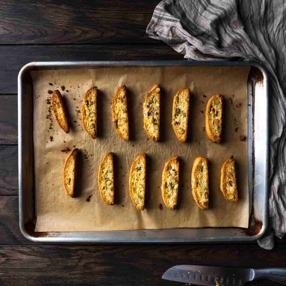 Crispy twice baked pistachio biscotti on a cookie sheet