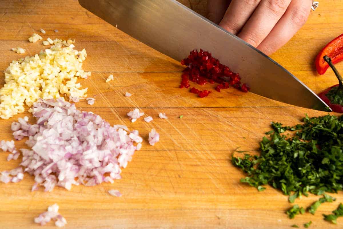 Finely minced ingredients on a cutting board