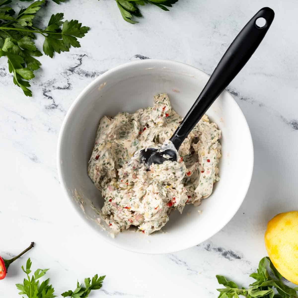 A bowl of soft chimichurri butter.