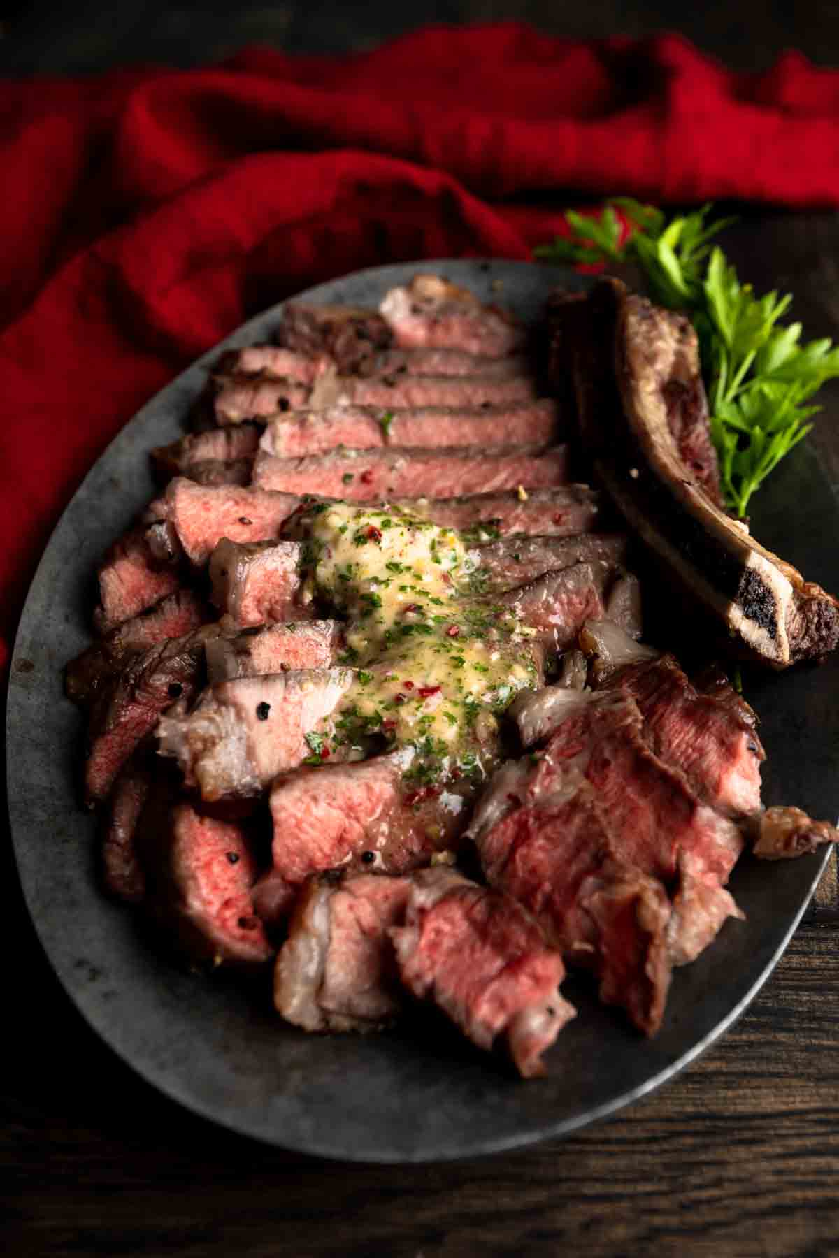 Chimichurri butter melting over a sliced steak