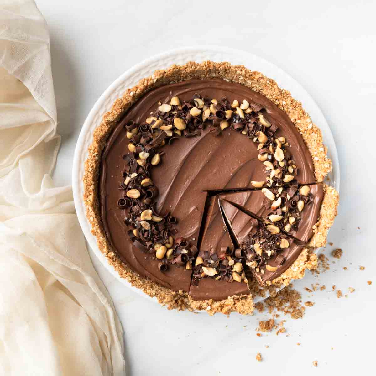 Three slices cut in a whole chocolate peanut butter pie