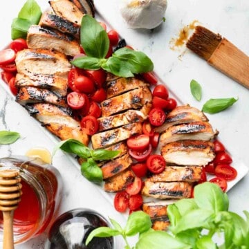 An overhead shot of a platter of grilled honey balsamic chicken