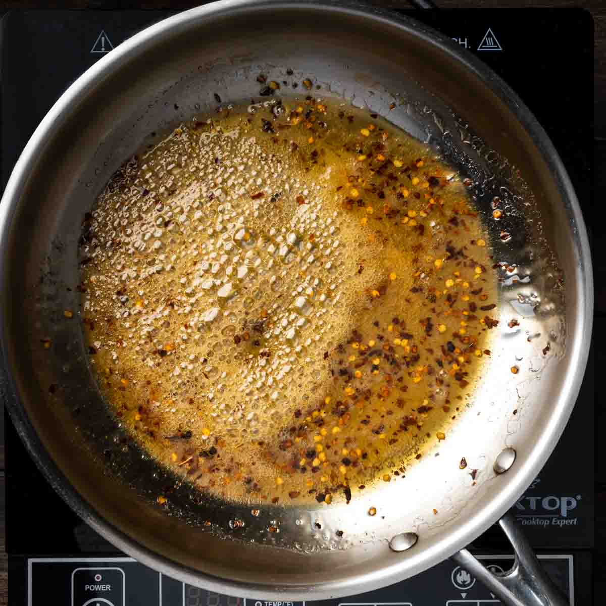 Honey simmering with chili flakes