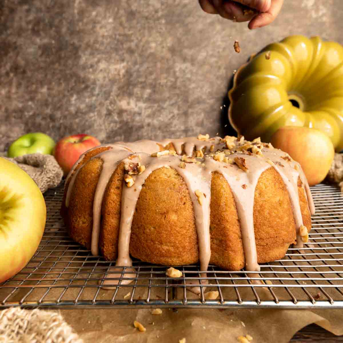 Sprinkling toasted walnuts over the cake