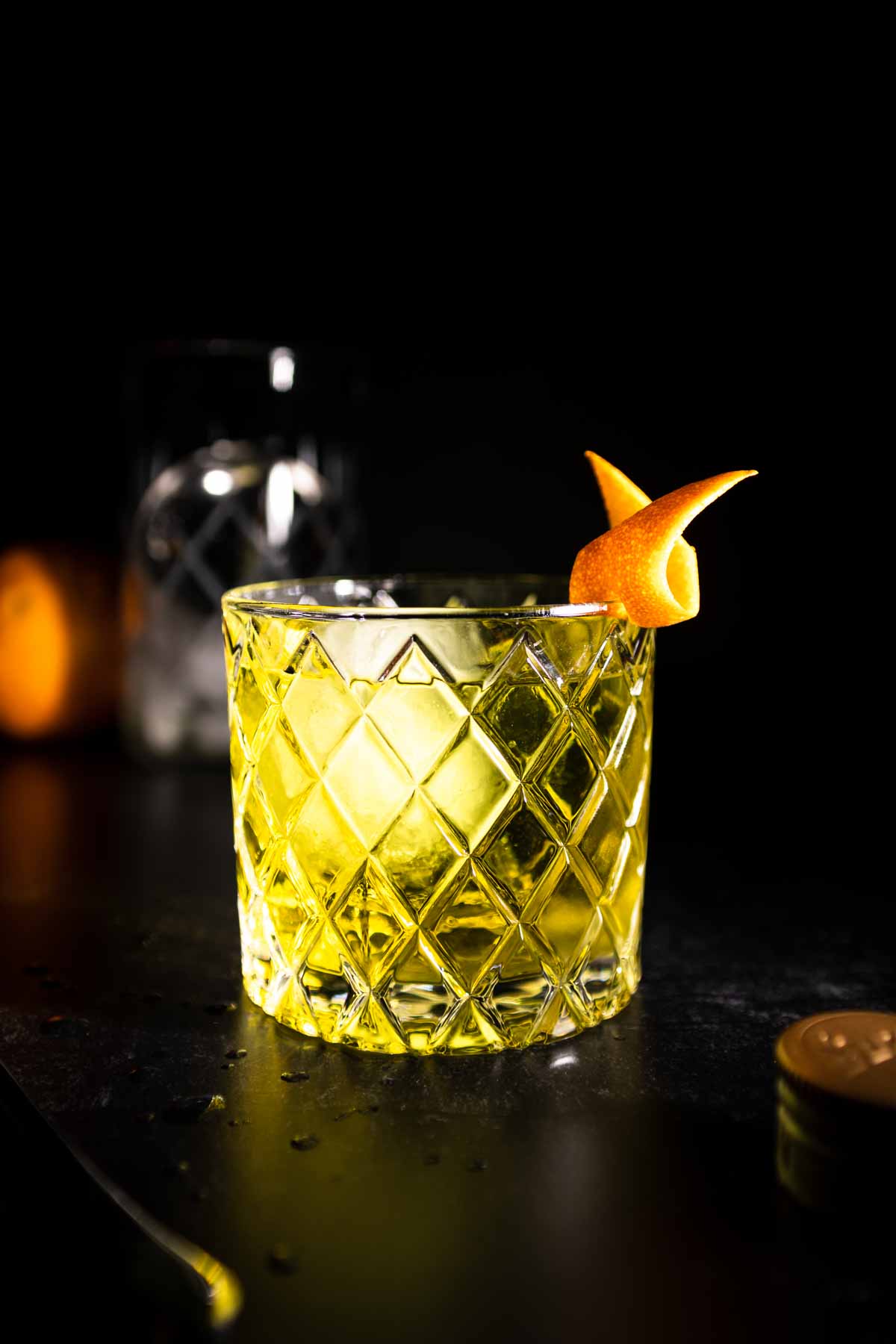 A white mezcal negroni garnished with an orange twist