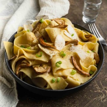 A big bowl of matsutake miso butter pasta garnished with scallion