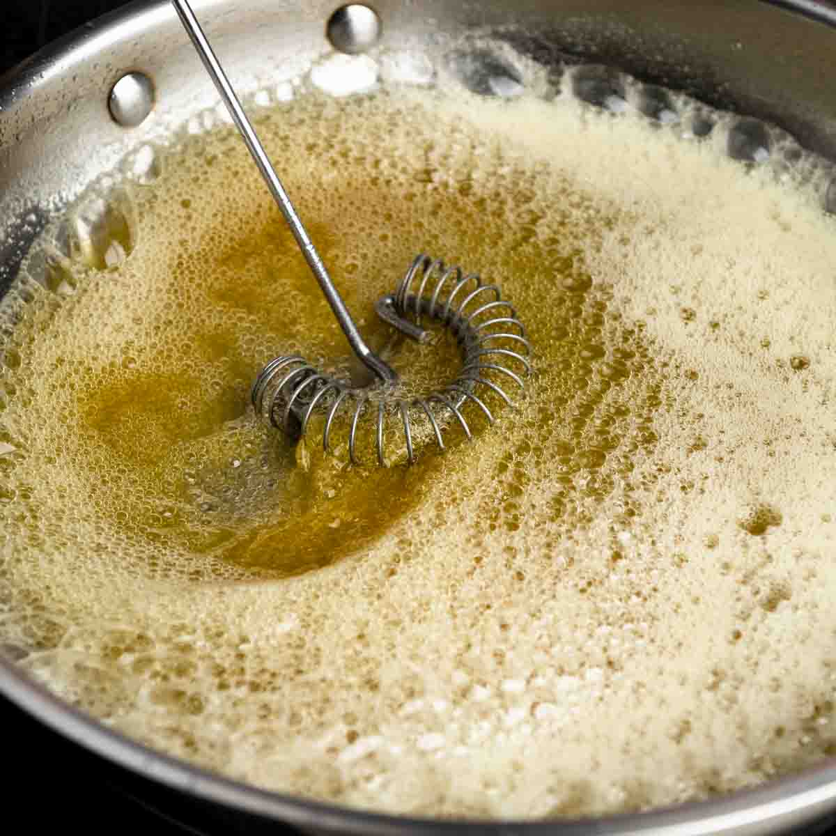 Whisking foamy brown butter in the pan