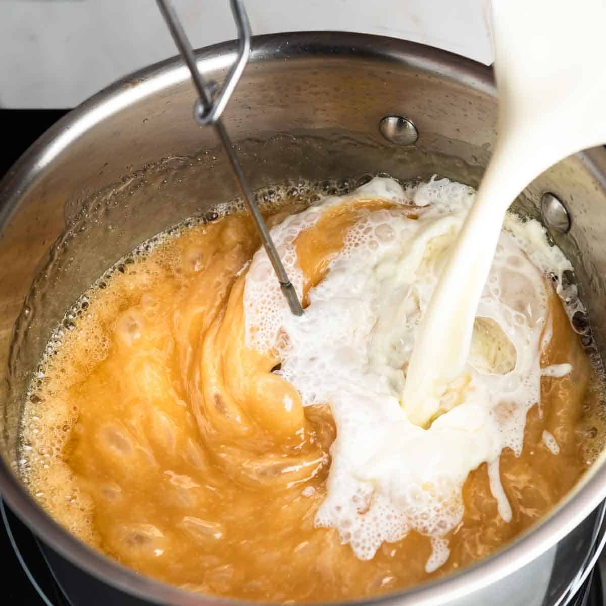 Whisking cream into bubbly caramel sauce