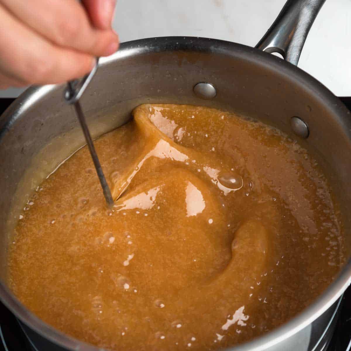 Silky homemade caramel sauce in a pot