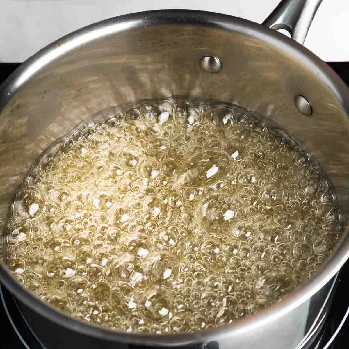 Boiling syrup beginning to caramelize on the pot