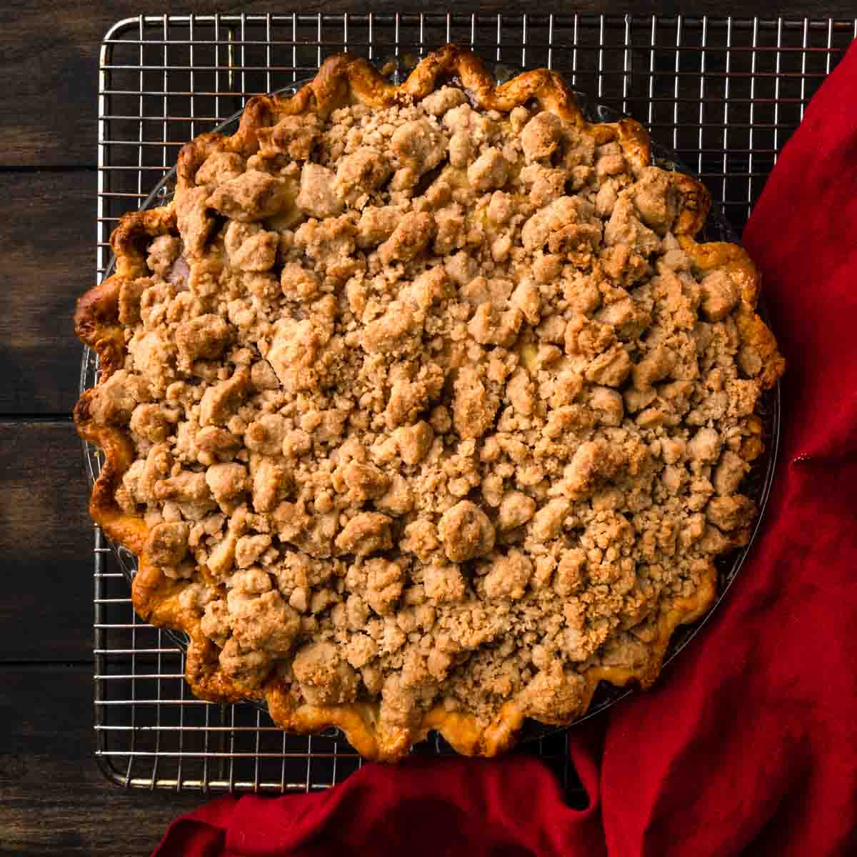 Freshly baked Dutch Apple Pie with Brown Butter Crumble cooling on a rack