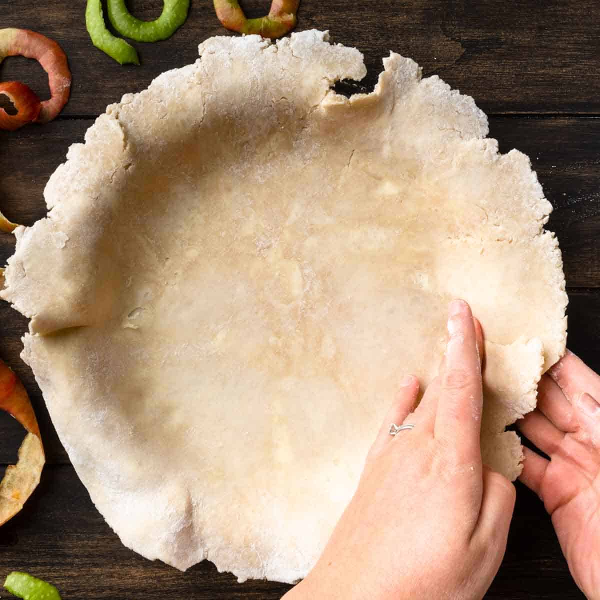 Pressing homemade pie crust into a pie plate