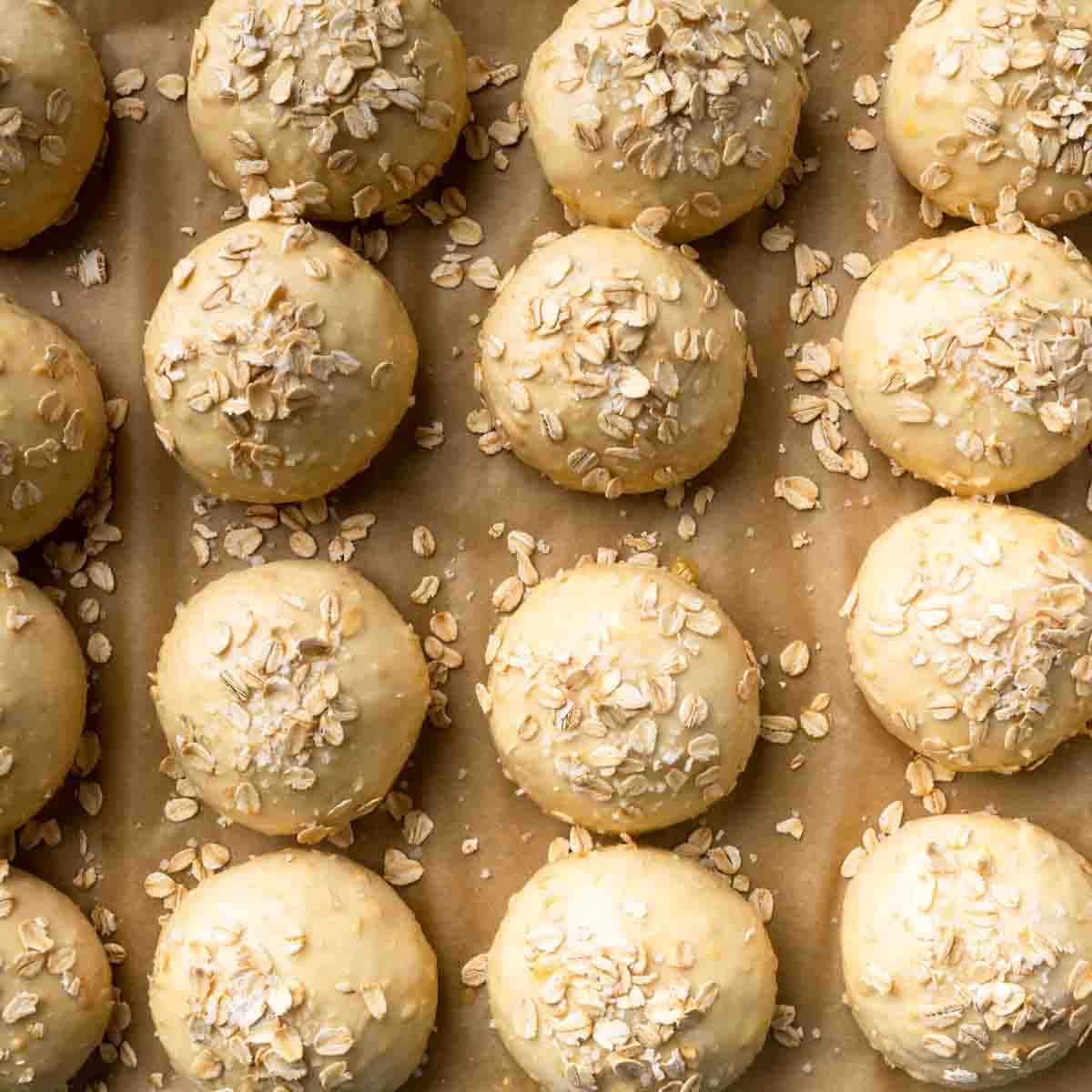 Unbaked round rolls sprinkled with old fashioned rolled oats and salt