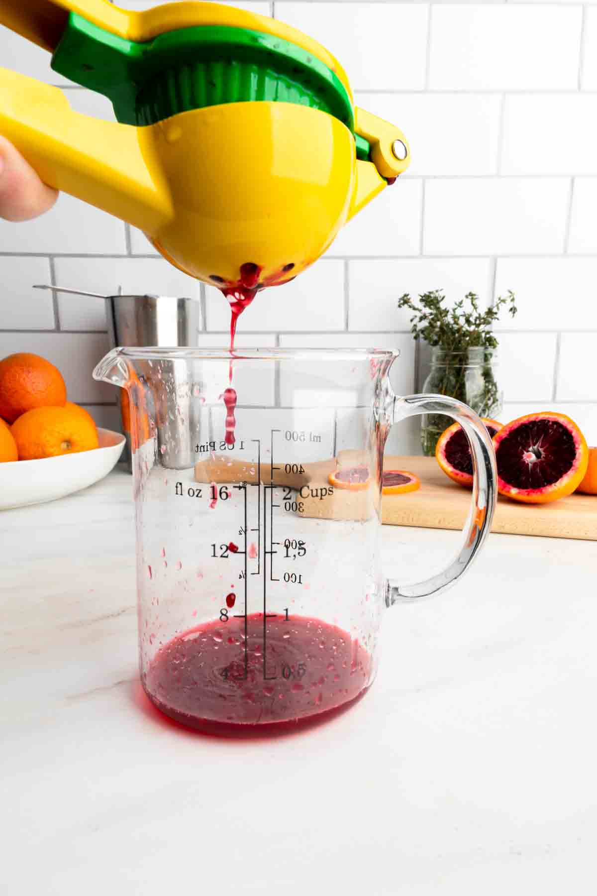 Using a citrus juicer to make freshly squeezed blood orange juice. 