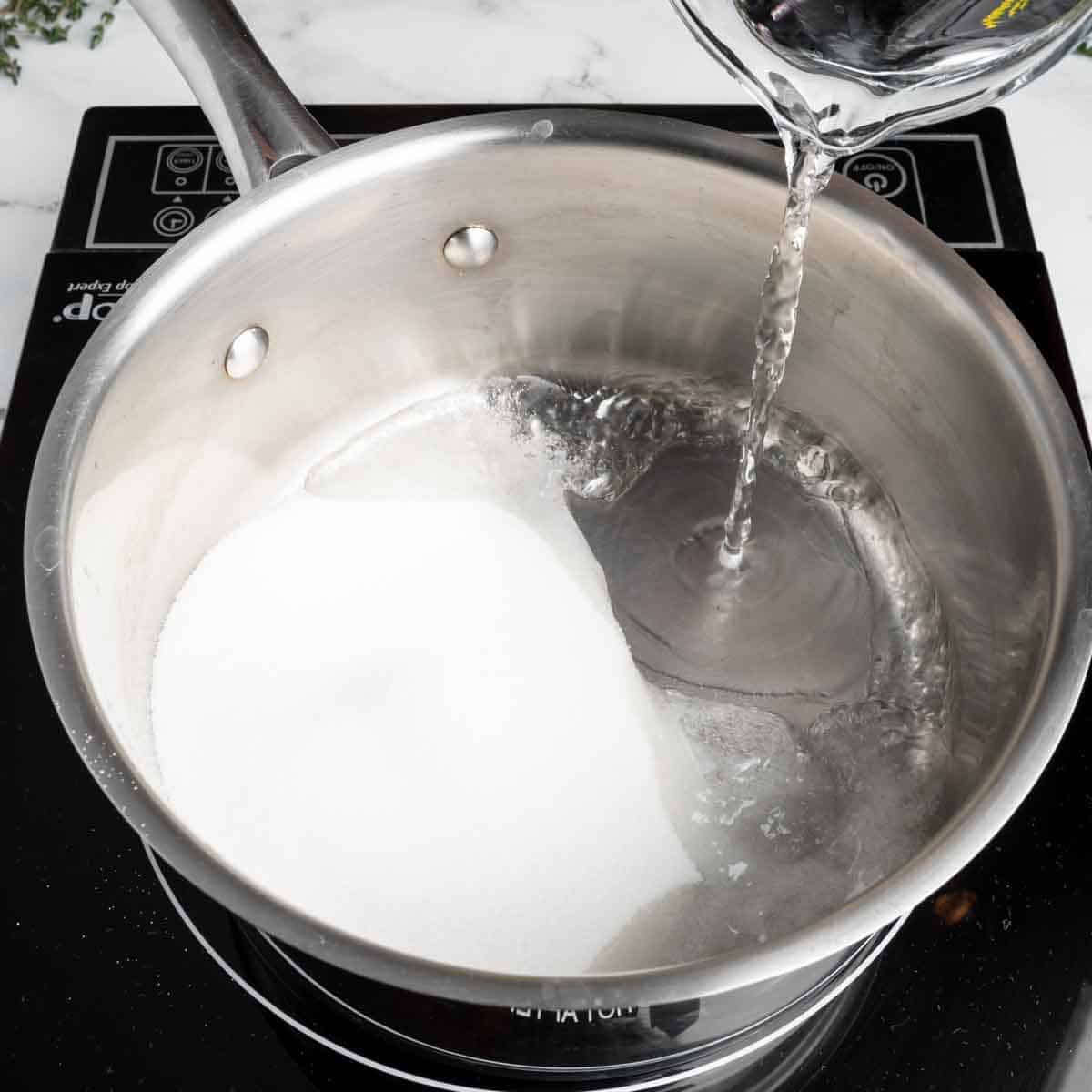 Pouring water into a pot of sugar.