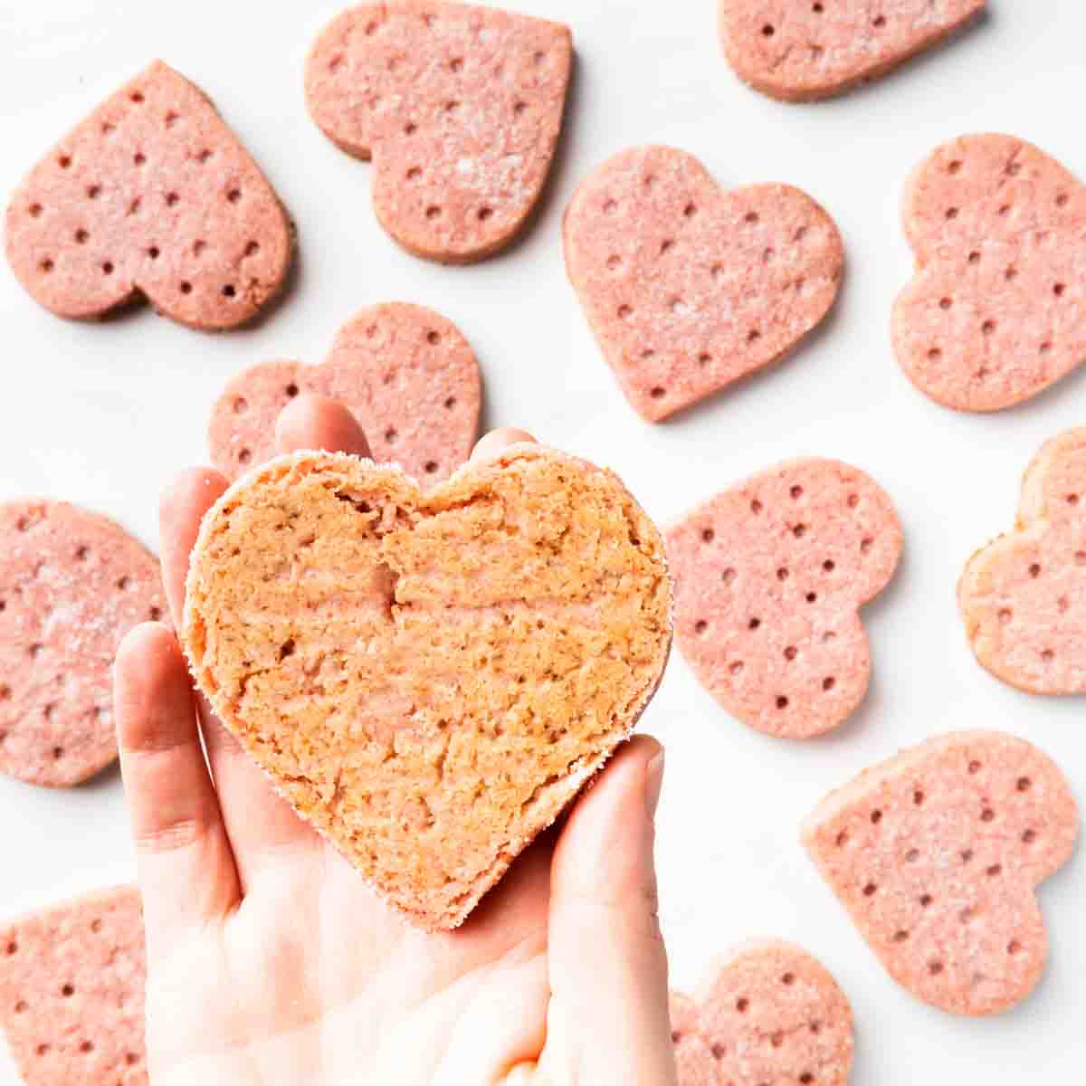 Showing the bottom of a heart shaped cookie with a barely golden coloring.