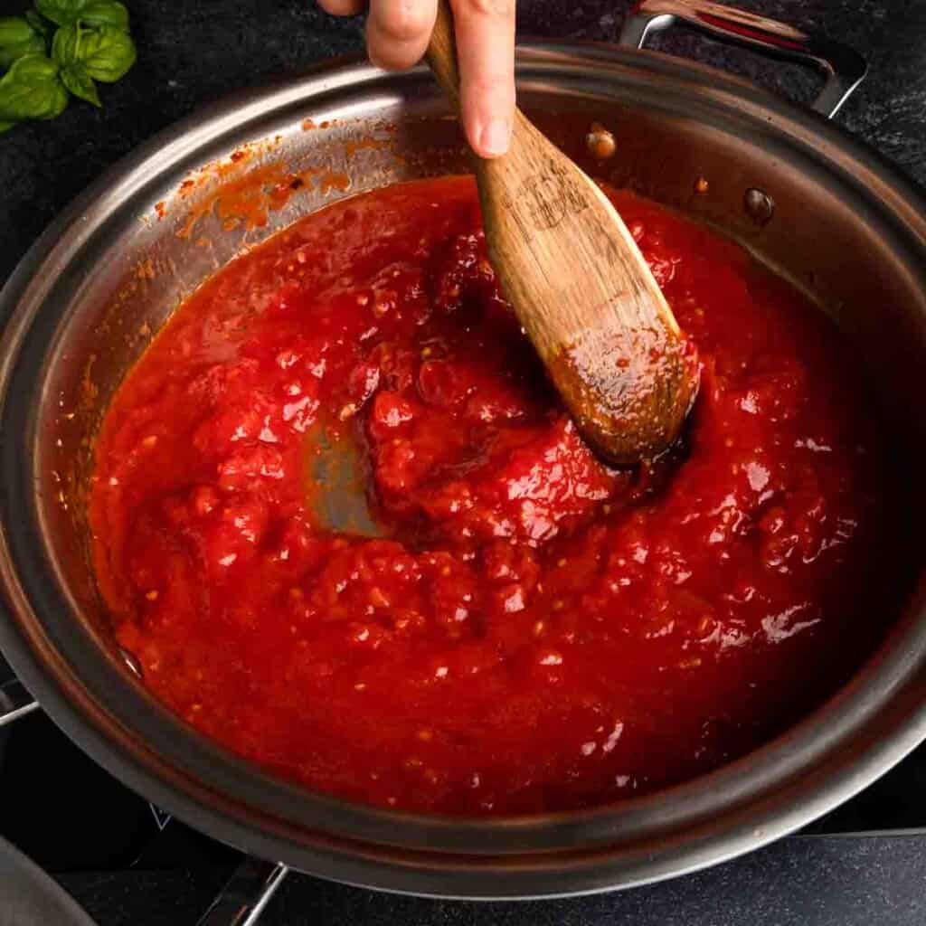 Stirring the finished Italian tomato sauce on the pan. 