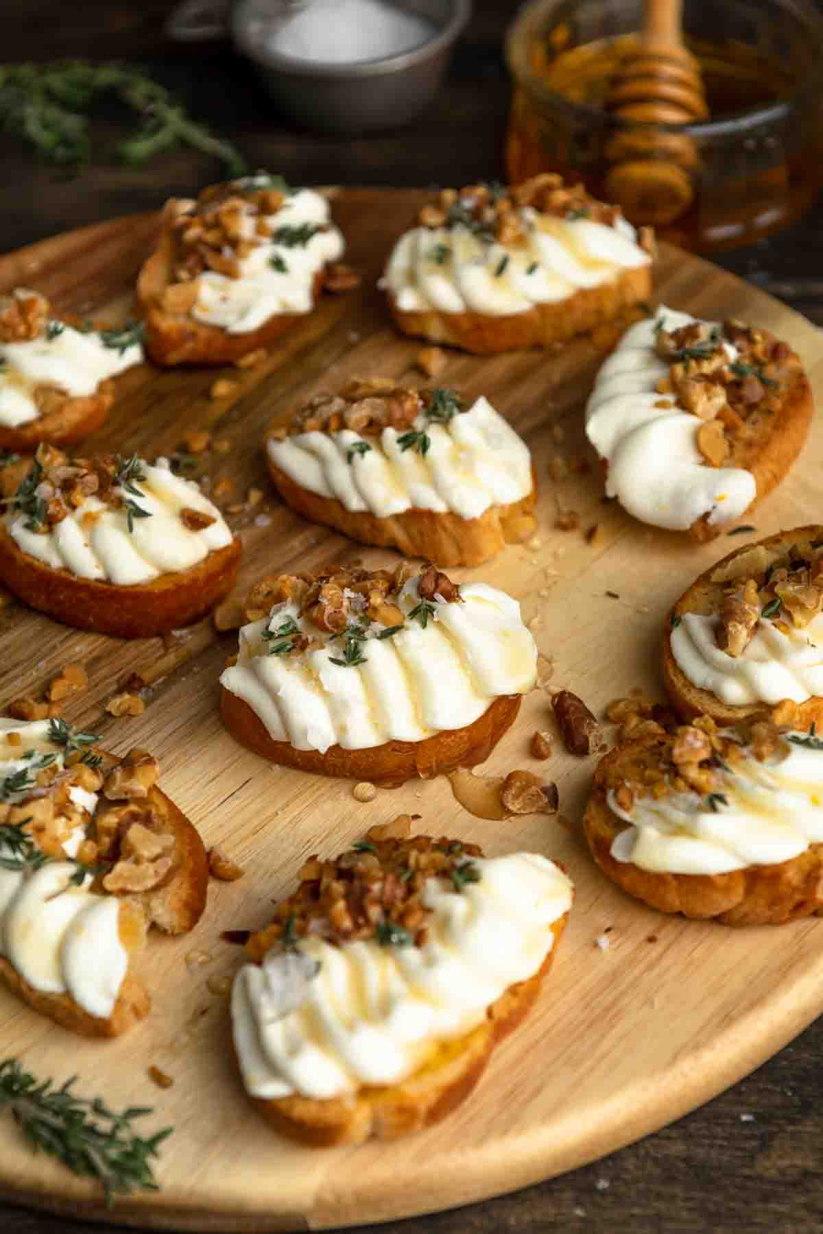 A board of whipped ricotta crostini with honey, toasted walnuts and thyme. 