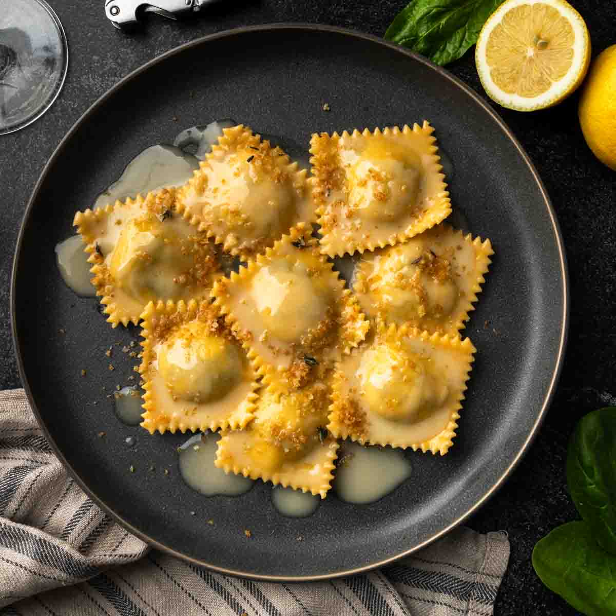 A plate of homemade ravioli dressed in white wine lemon butter sauce.