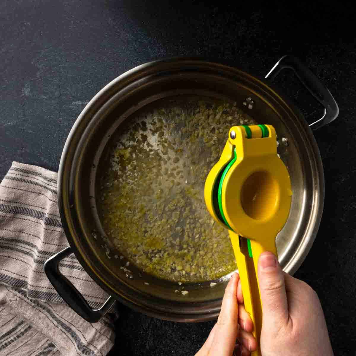 Squeezing lemon juice into the sauce pan. 
