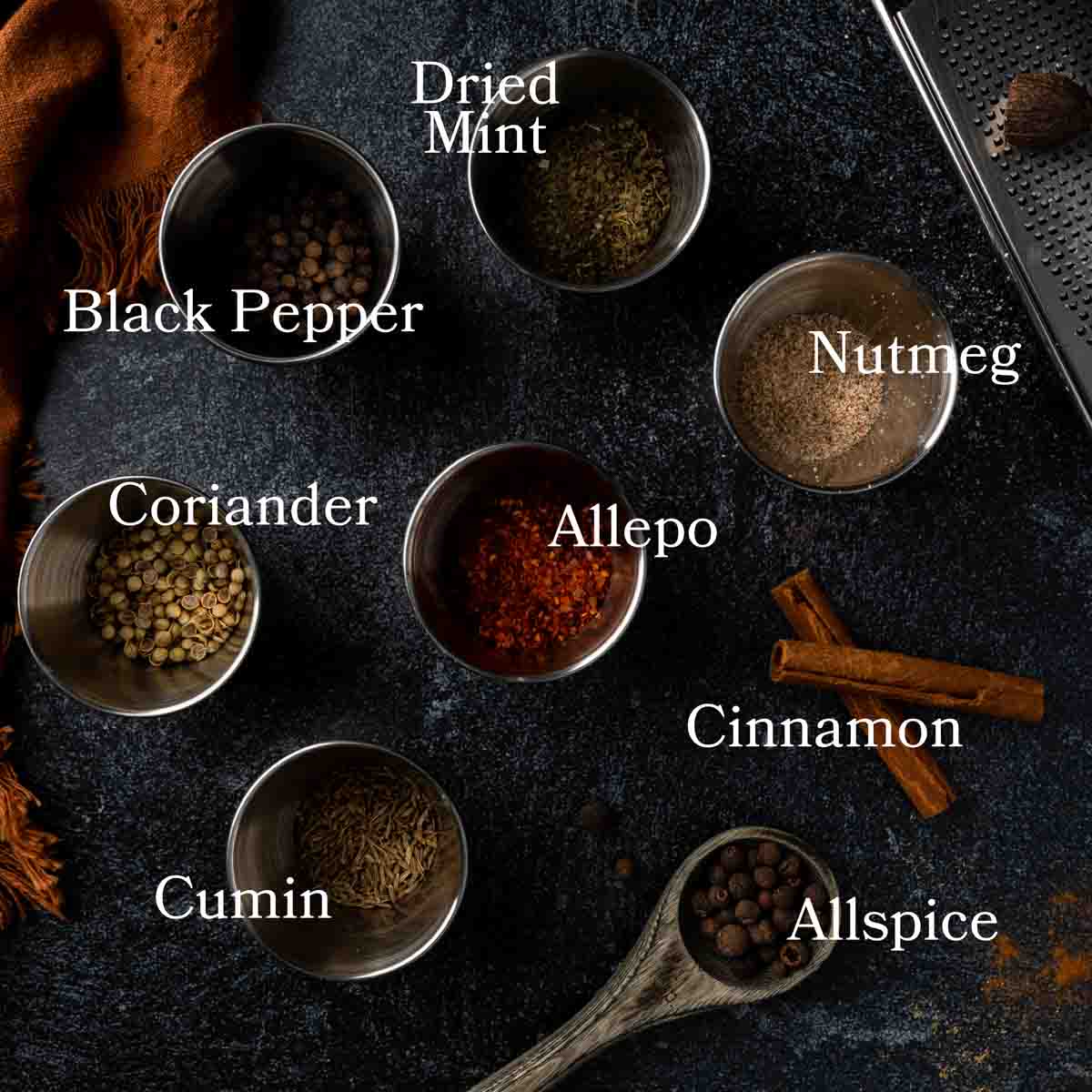  labeled image of the spices needed to make homemade baharat.