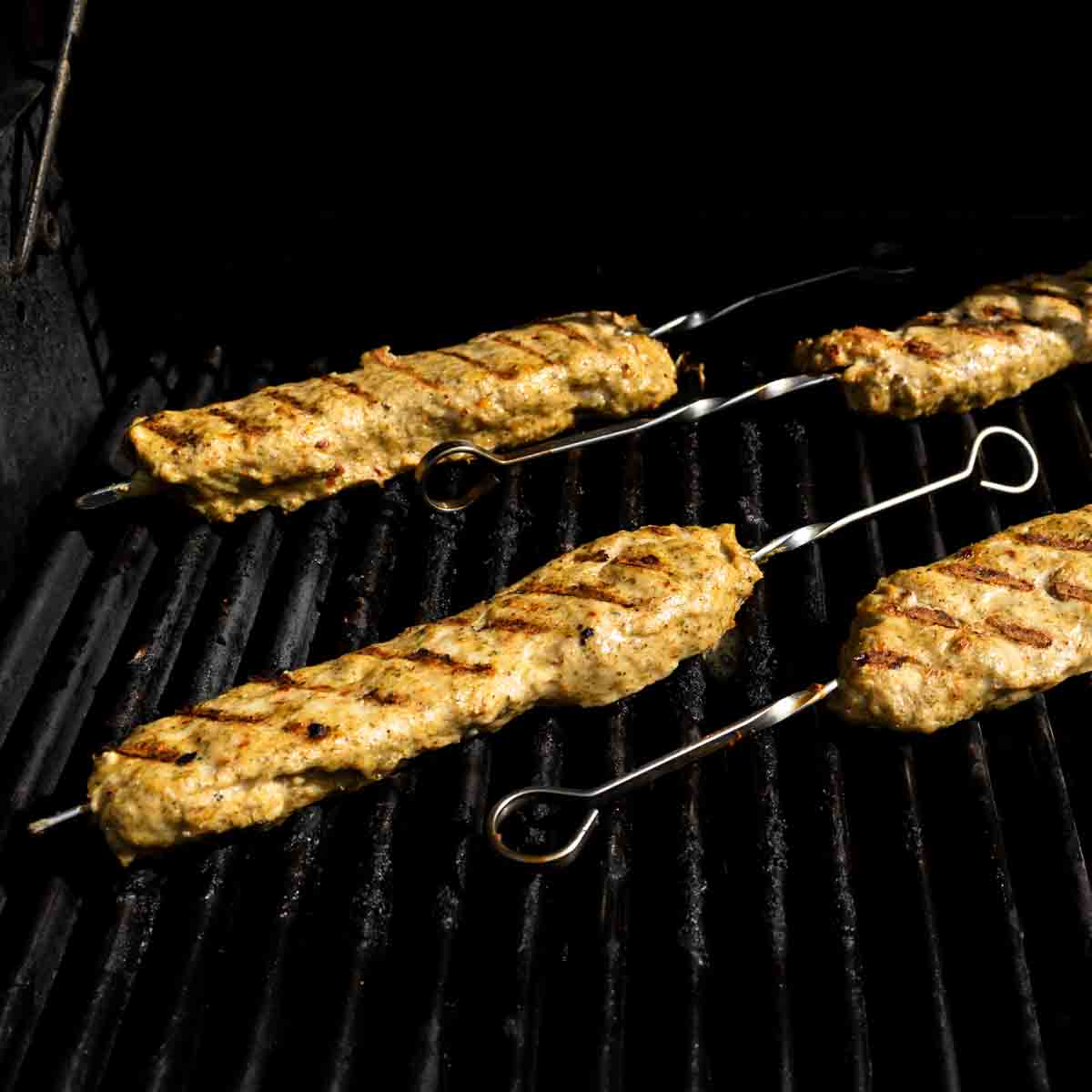 Chicken kofta kebabs on the grill.